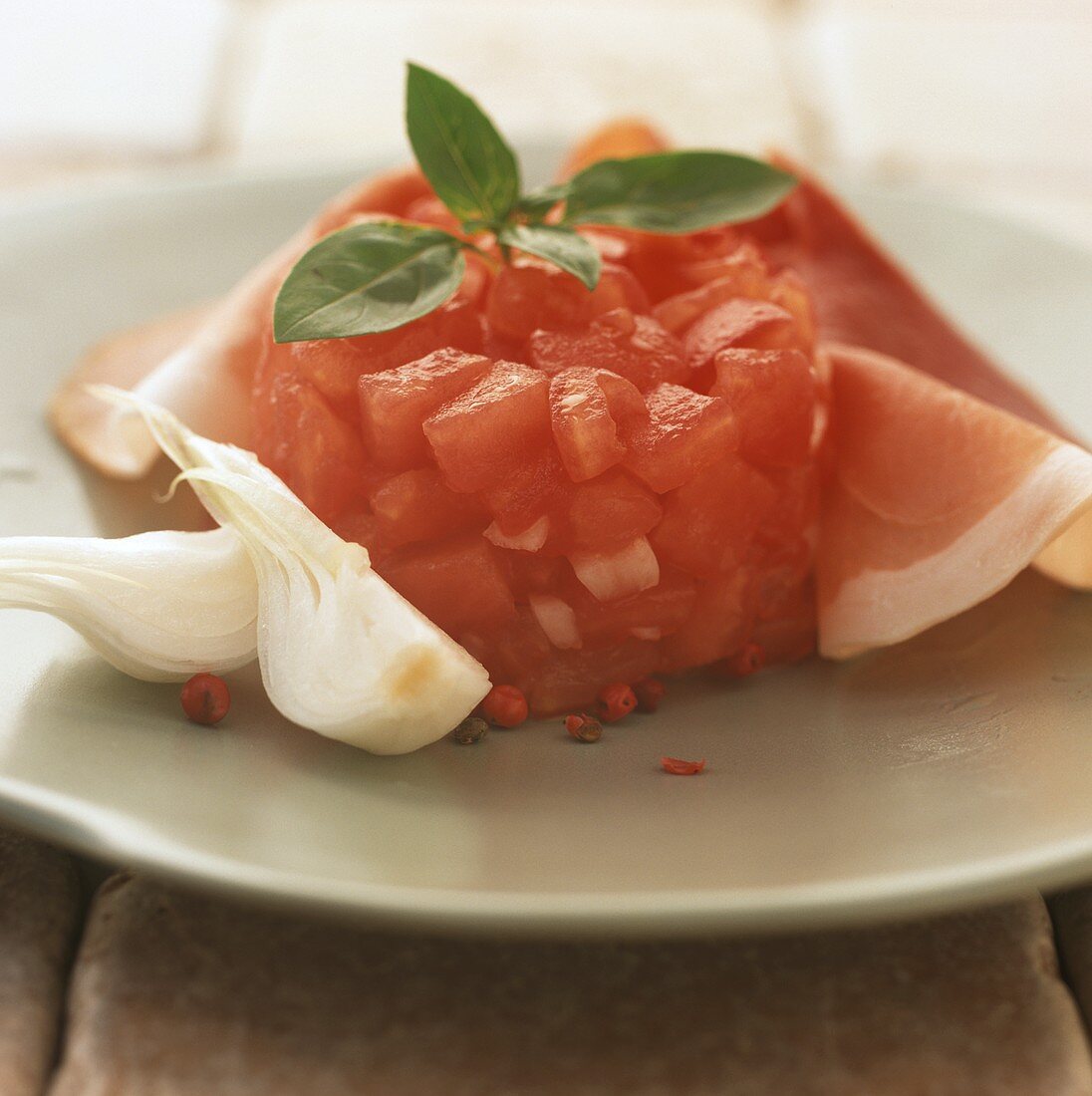 Chopped tomato timbale with ham and onions