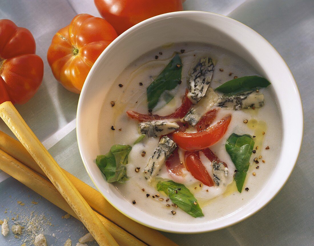 Creamed cheese soup with gorgonzola cream & tomato pieces