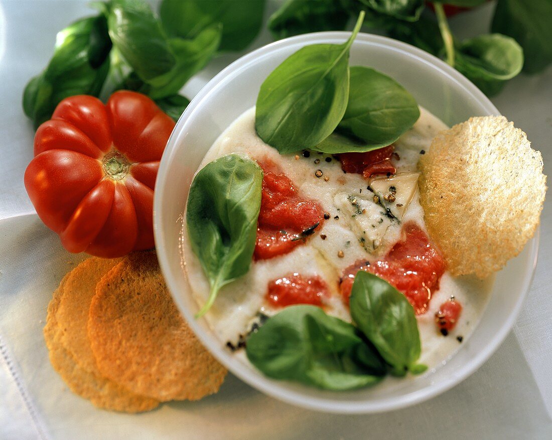Cream cheese soup with cream gorgonzola & tomato pieces