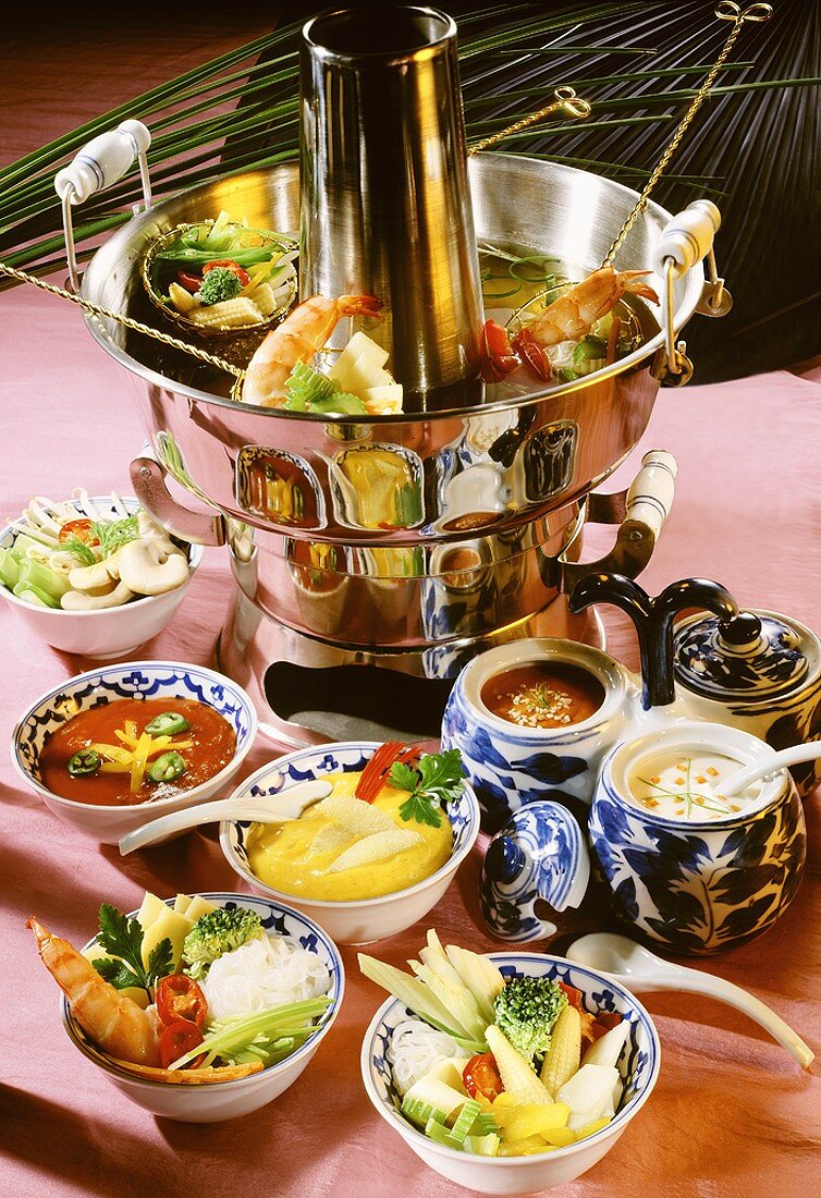 Fondue scene with various ingredients in bowls