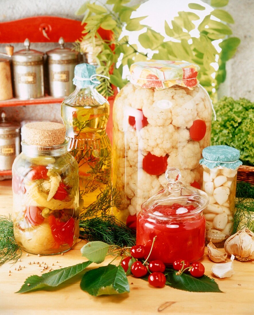 Pickled vegetables and sour cherries in jars