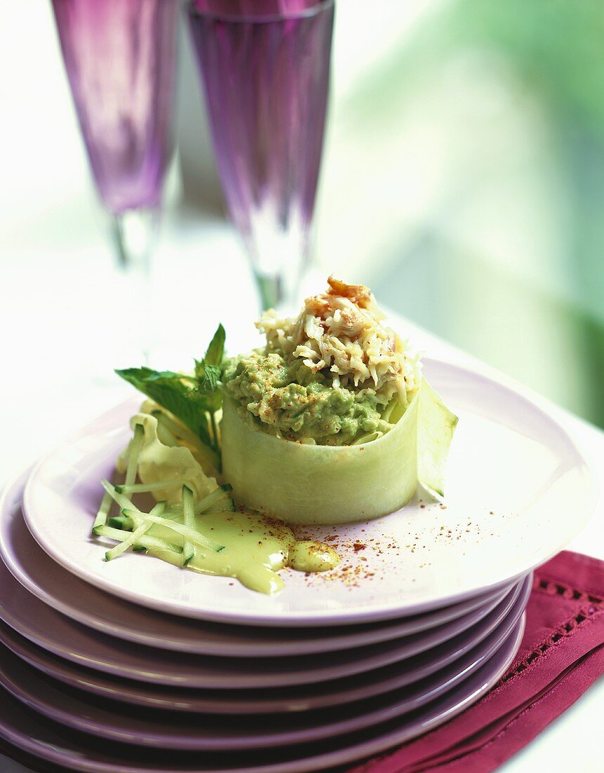 Cucumber snacks with guacamole and crab meat