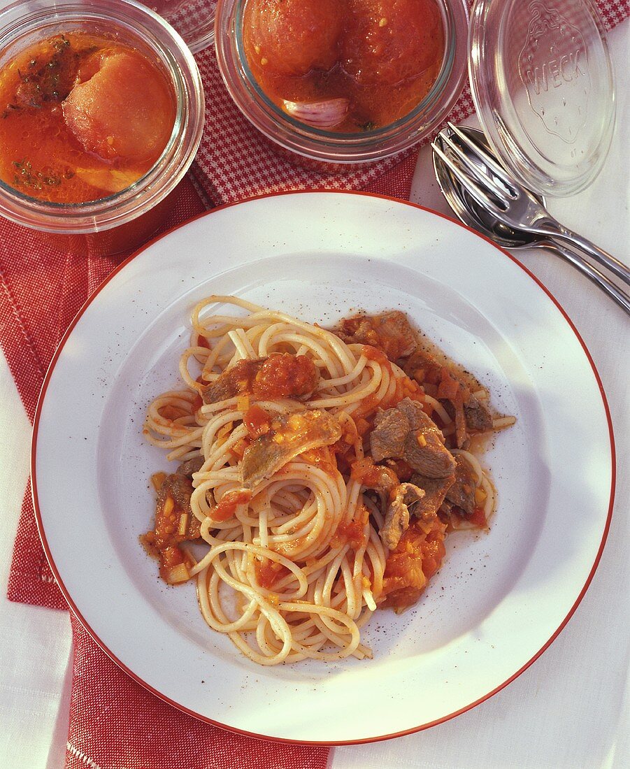 Spaghetti with tomato sauce & duck breast fillets on plate
