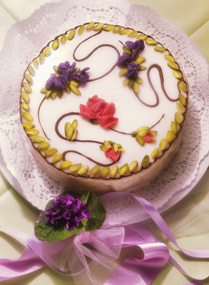 Decorated spring cake; posy of violets