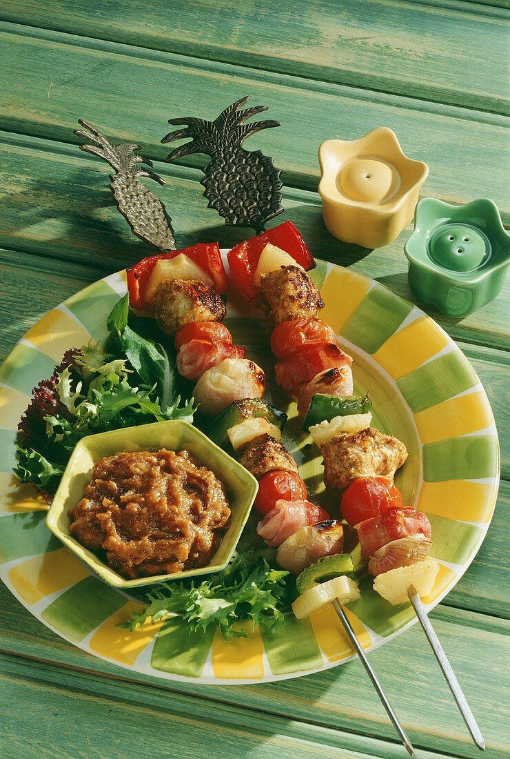 Two chicken and vegetables kebabs with pineapples & dip