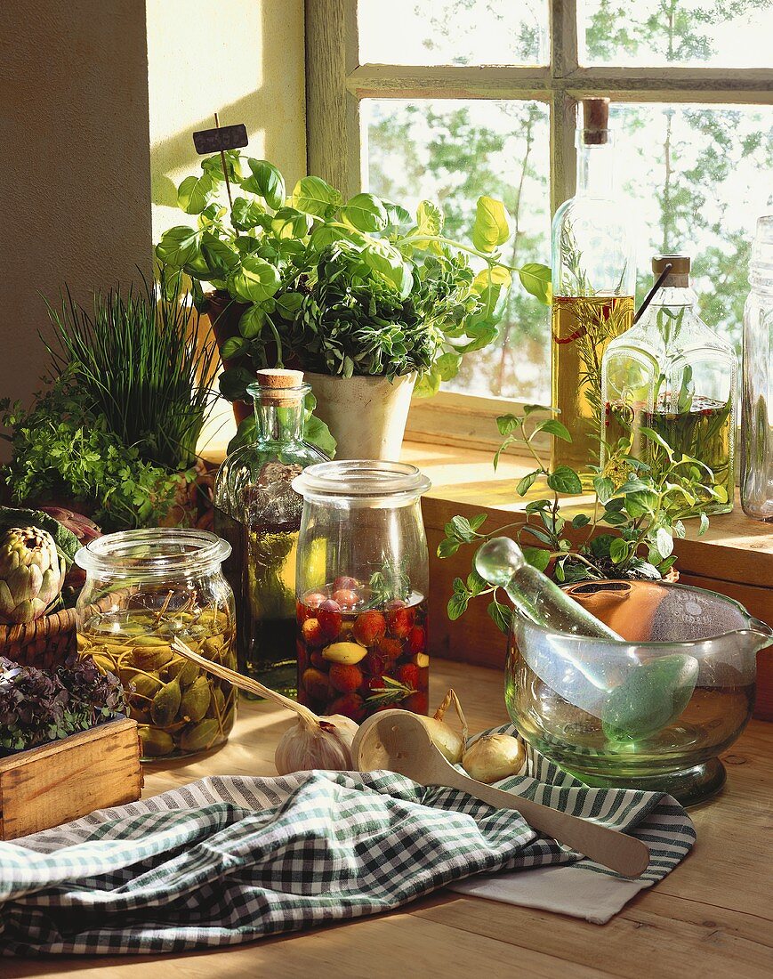 Bottled capers & olives, herbs, oils, vinegar and mortar