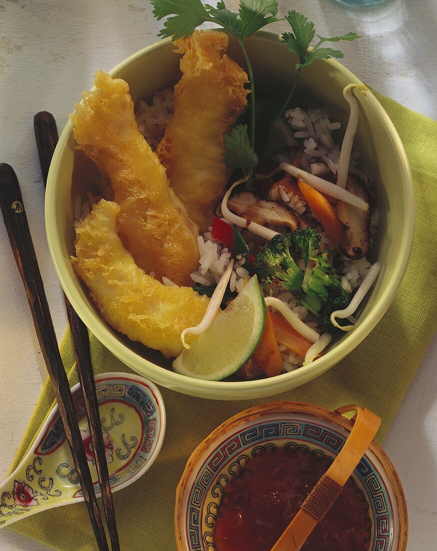 Fish snacks with vegetables, rice & chili sauce in bowl