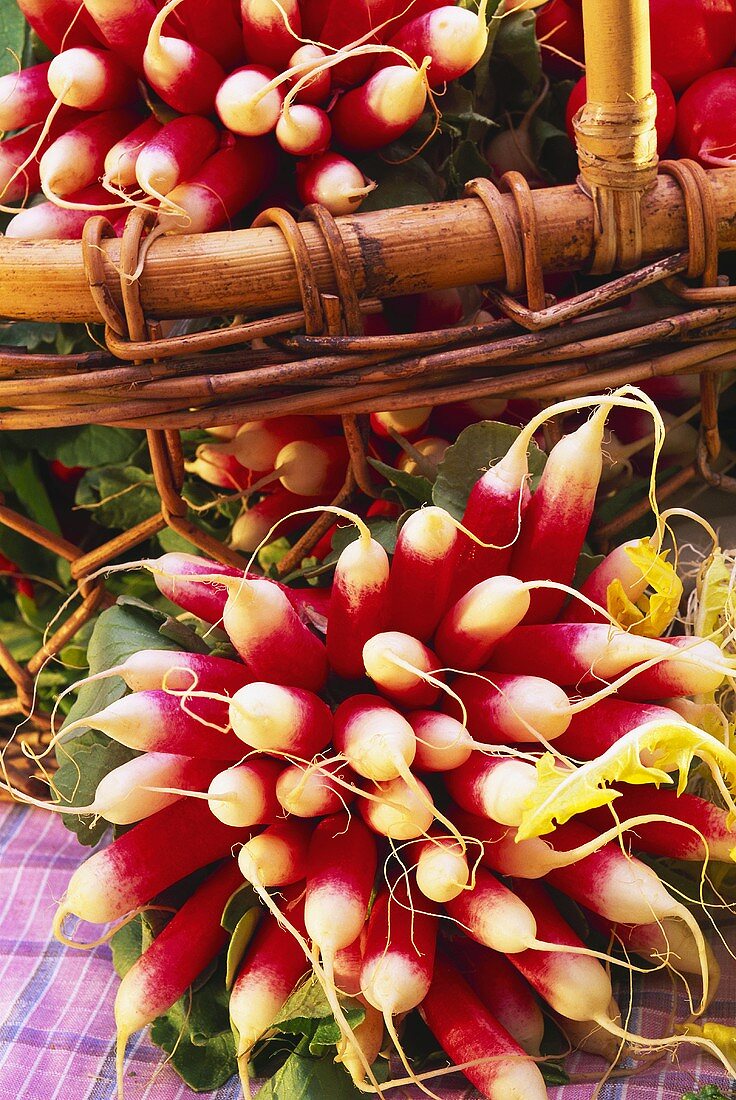 A bunch of radishes in front of a basket