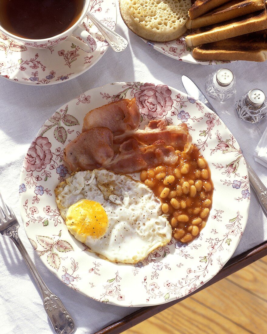 English breakfast with fried egg, bacon and baked beans