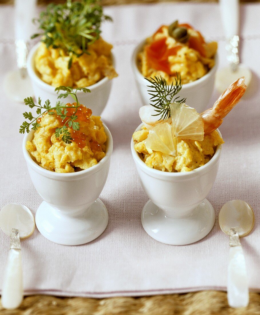 Scrambled egg with various toppings in egg cups