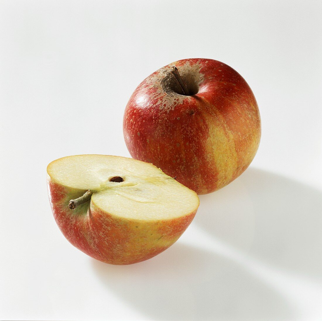 Whole and half apple (Cox's Orange Pippin)