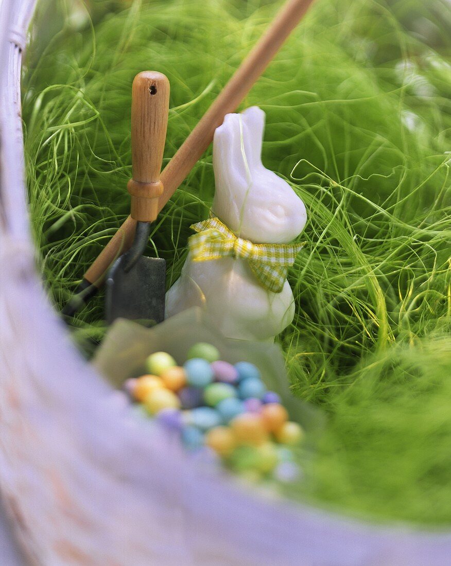 Decorative Easter bunny & sugar eggs on Easter grass in basket