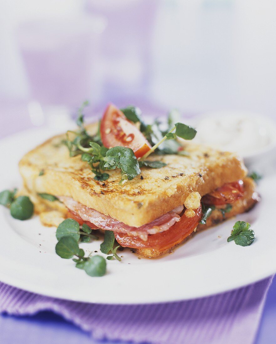 French toast sandwich with ham, salad and tomatoes