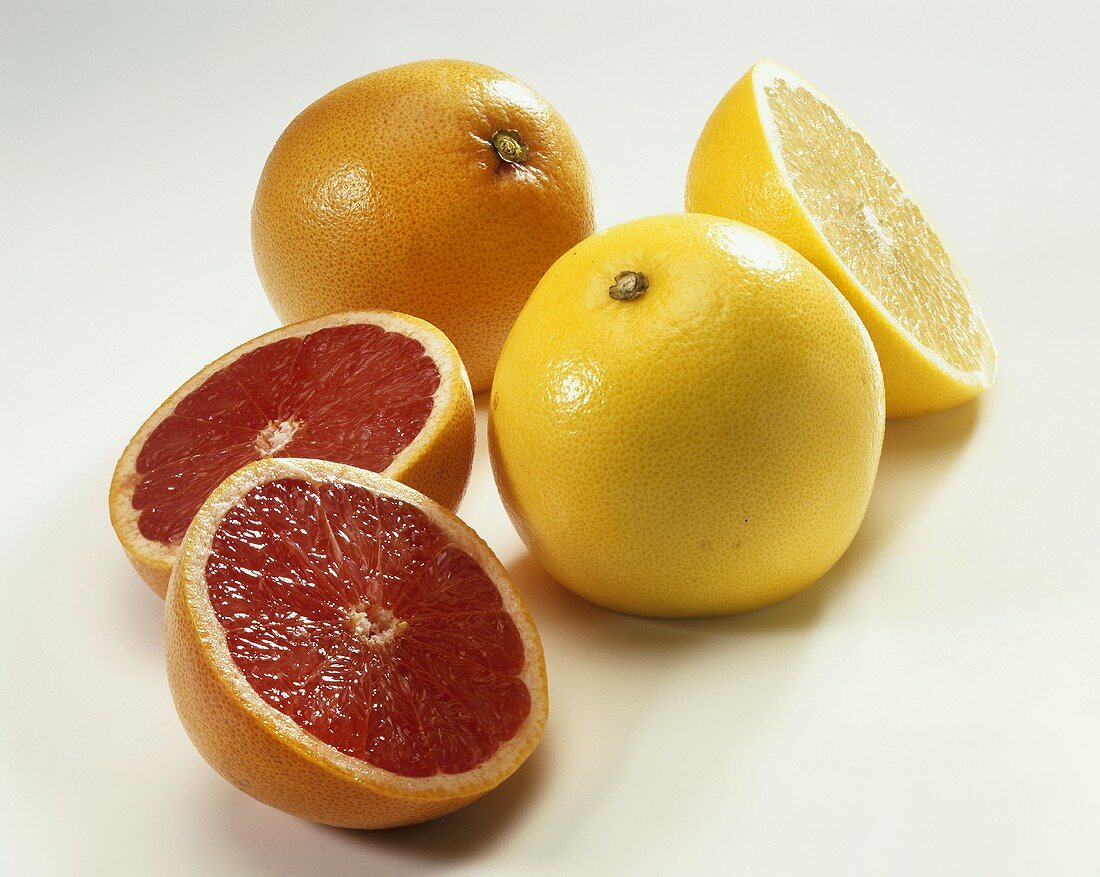 Pink and yellow grapefruit, whole and cut open