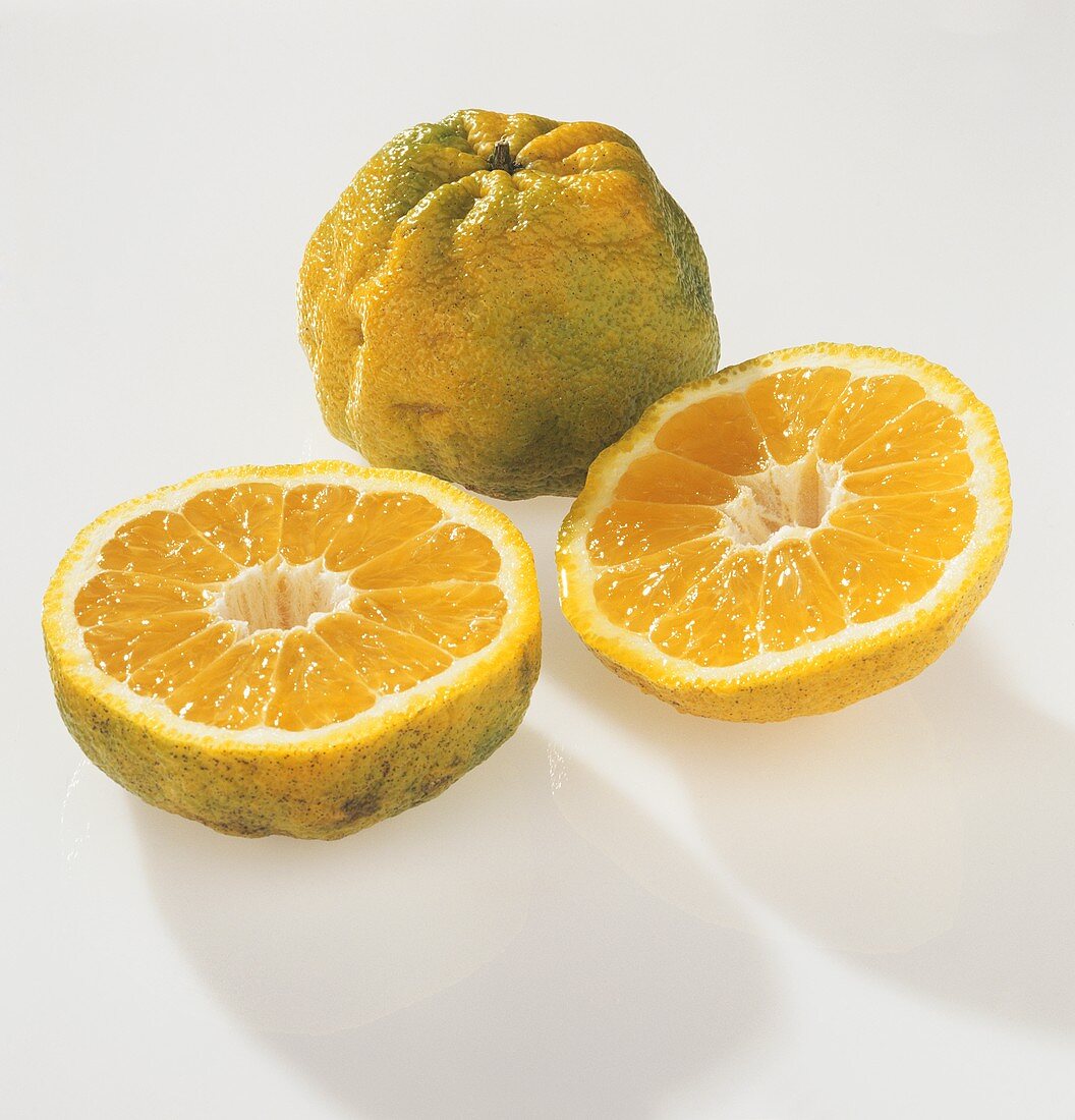 Whole and halved ugli fruit