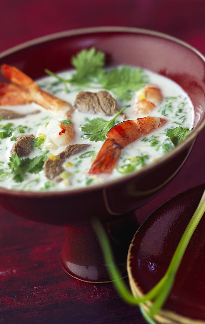Thai coconut soup with shrimps, beef and coriander