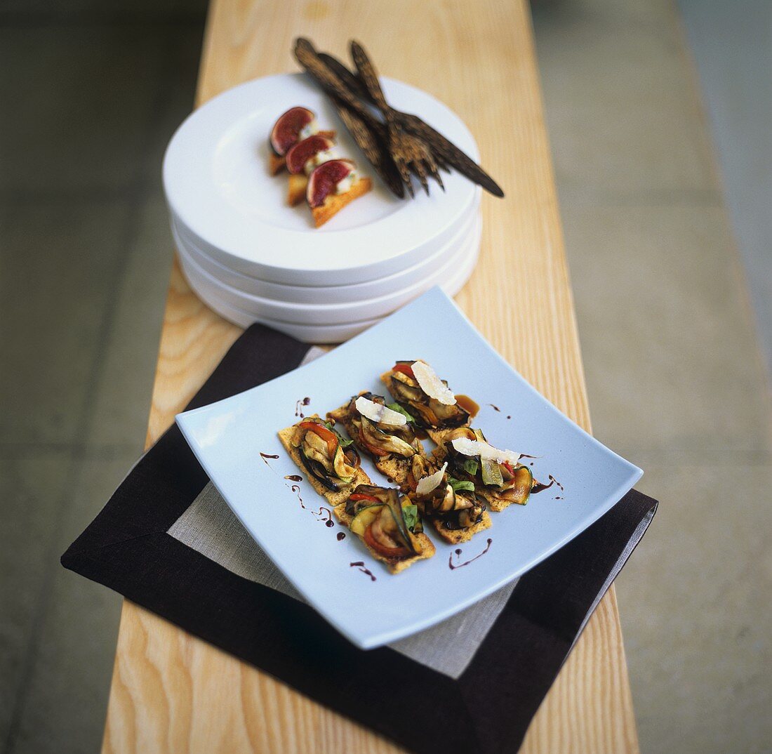 Vegetable canapes with parmesan and toast snacks with figs