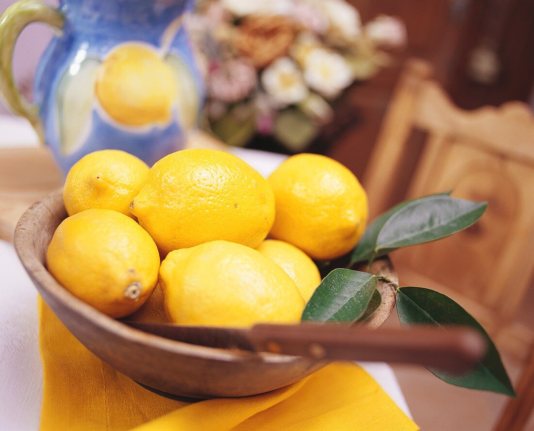 Lemons with knife in a bowl