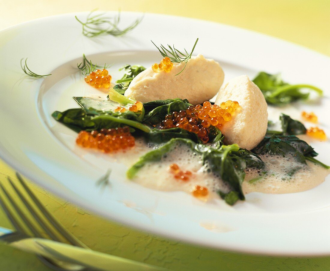 Pike dumplings with caviare on spinach