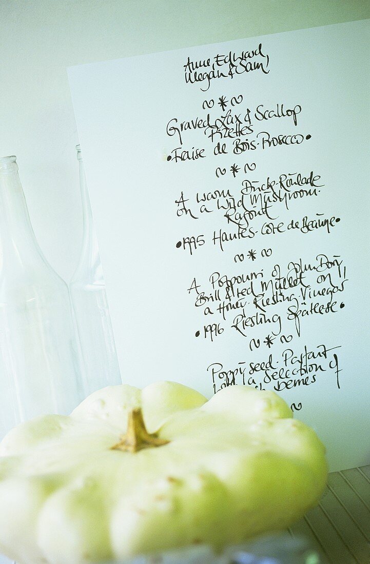 Menu, with a patty pan squash in front of it