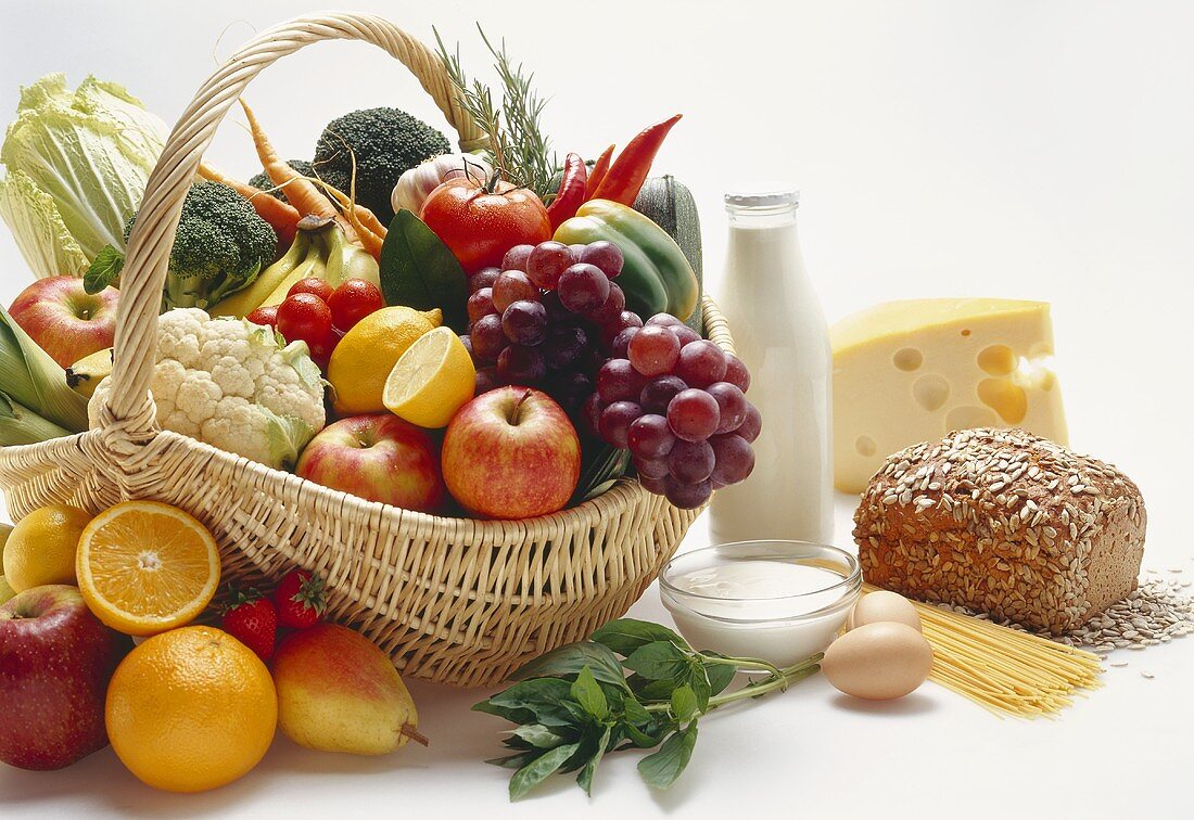 Various foods in and beside a basket