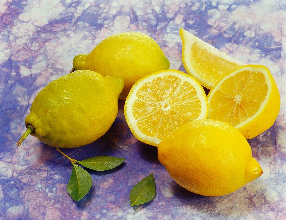 Whole lemons, lemon halves and a lemon wedge