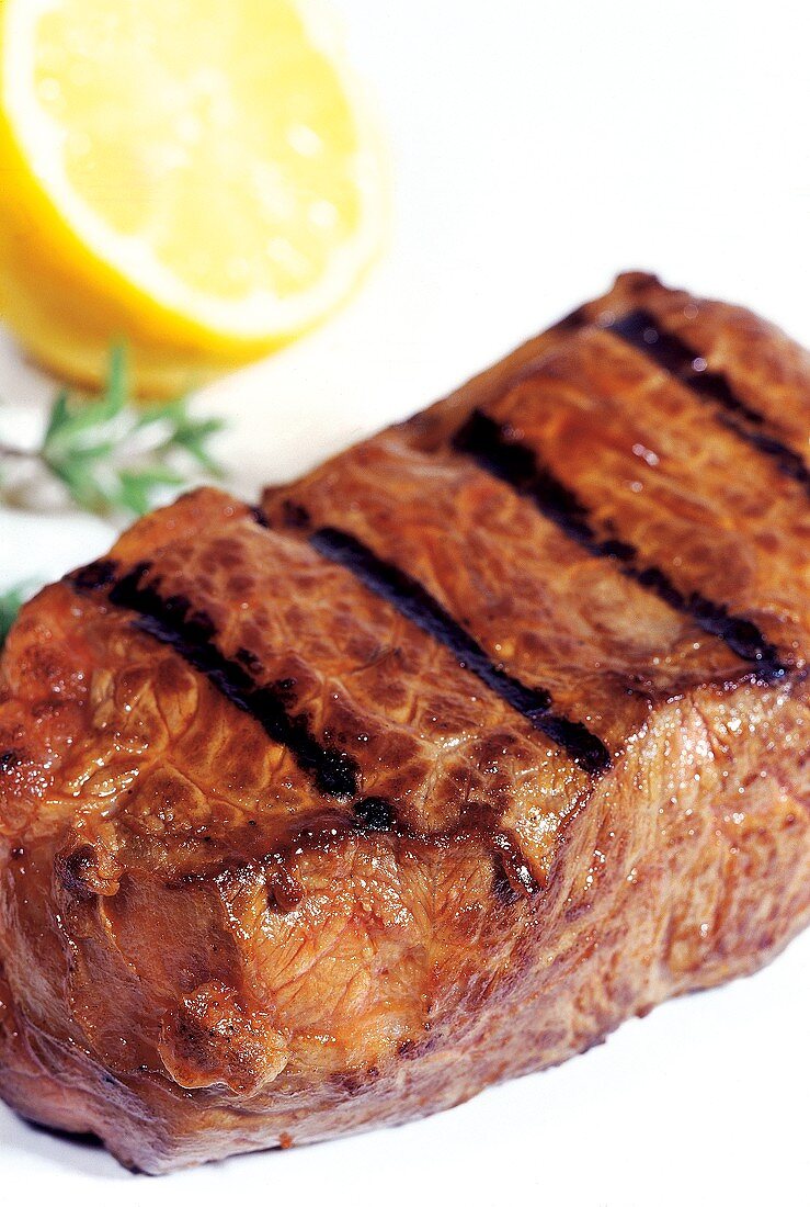 Grilled beef steak with lemon