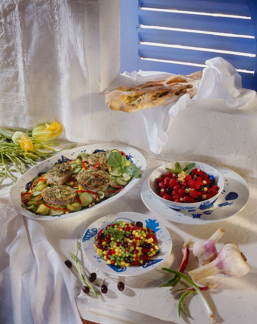 French menu with fish, sweetcorn salad and fruit salad