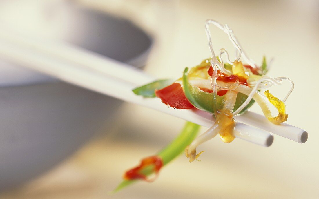 Glass noodles with vegetables on chopsticks