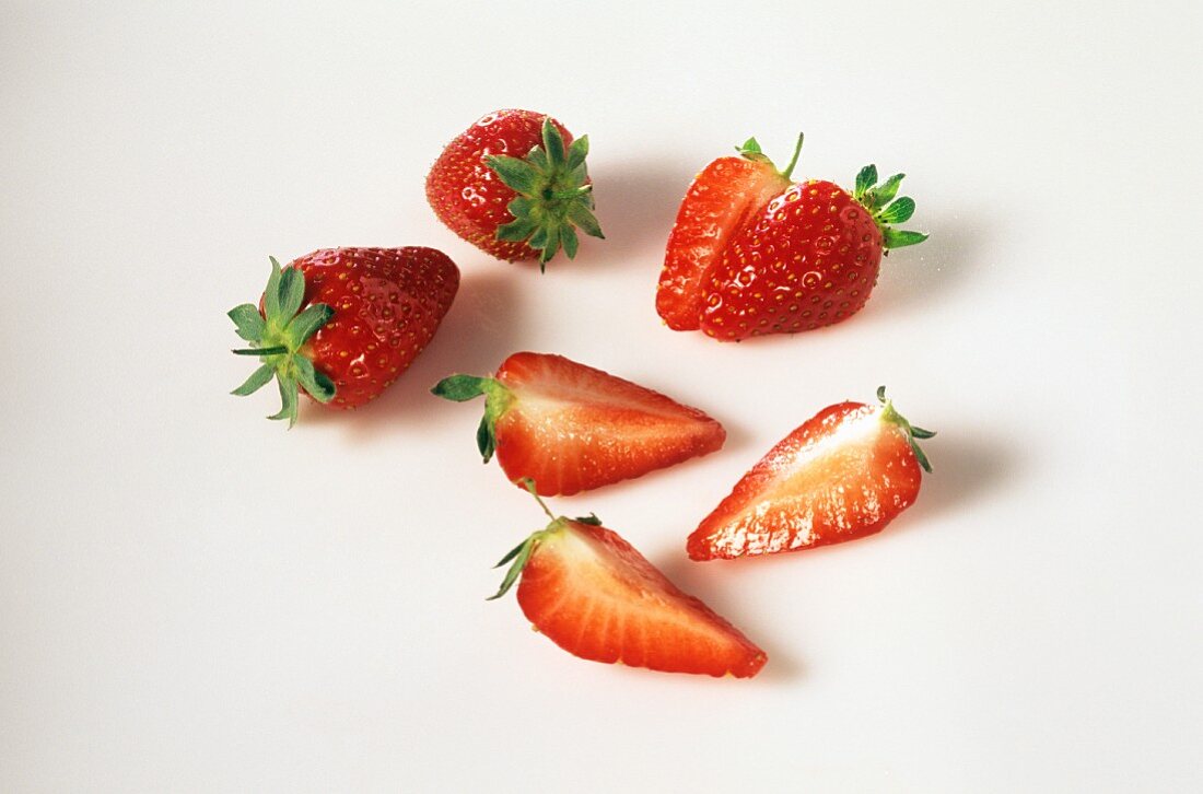 Whole and halved strawberries