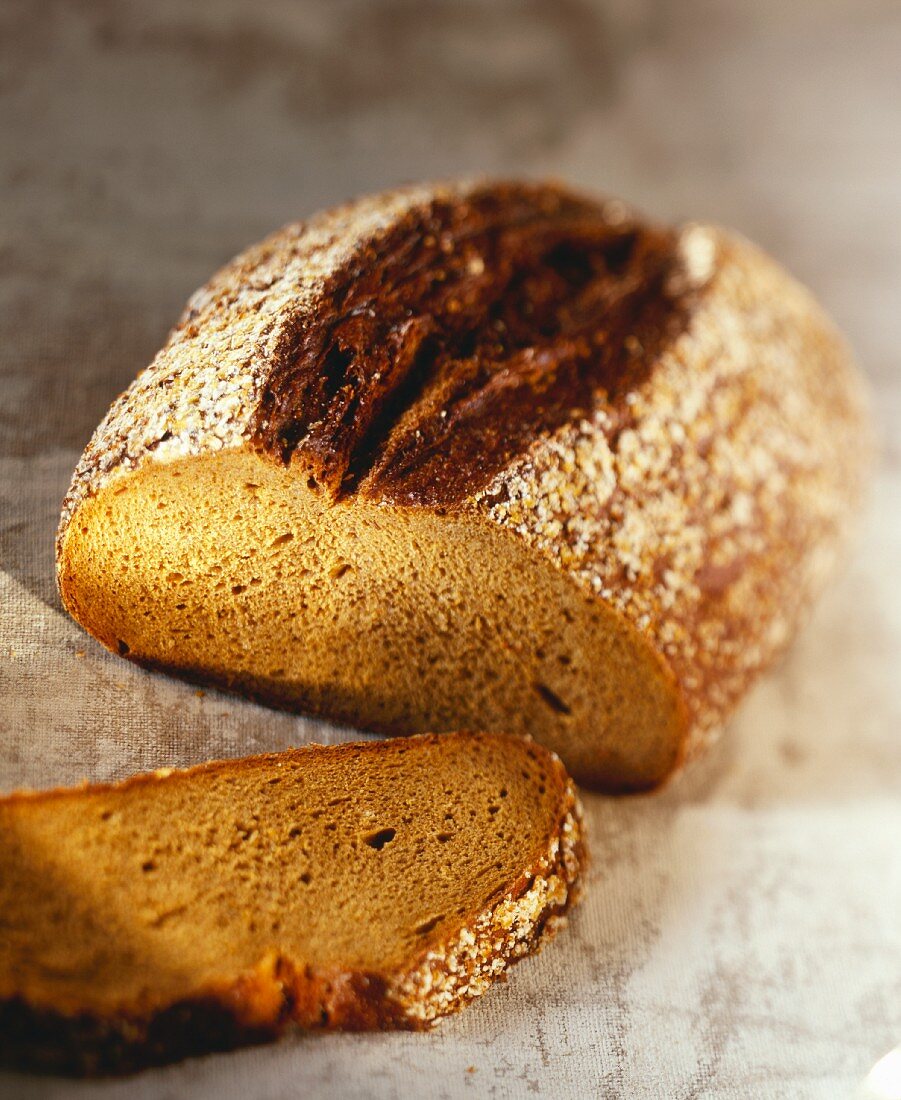 Ein angeschnittenes Sojabrot und eine Brotscheibe