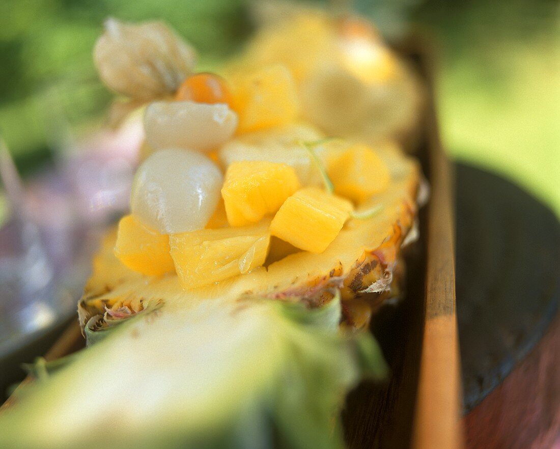 Exotic fruit salad in hollowed-out pineapple half