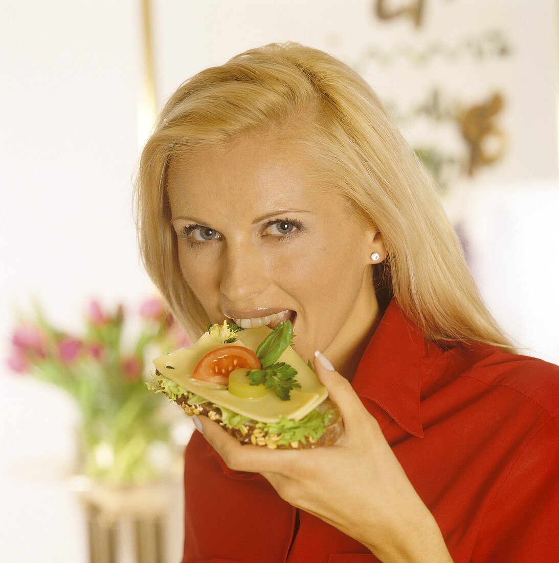 Woman eating a cheese sandwich