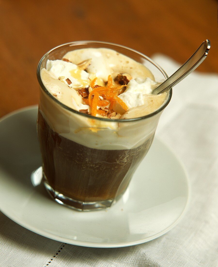 Iced coffee with whipped cream and orange zest