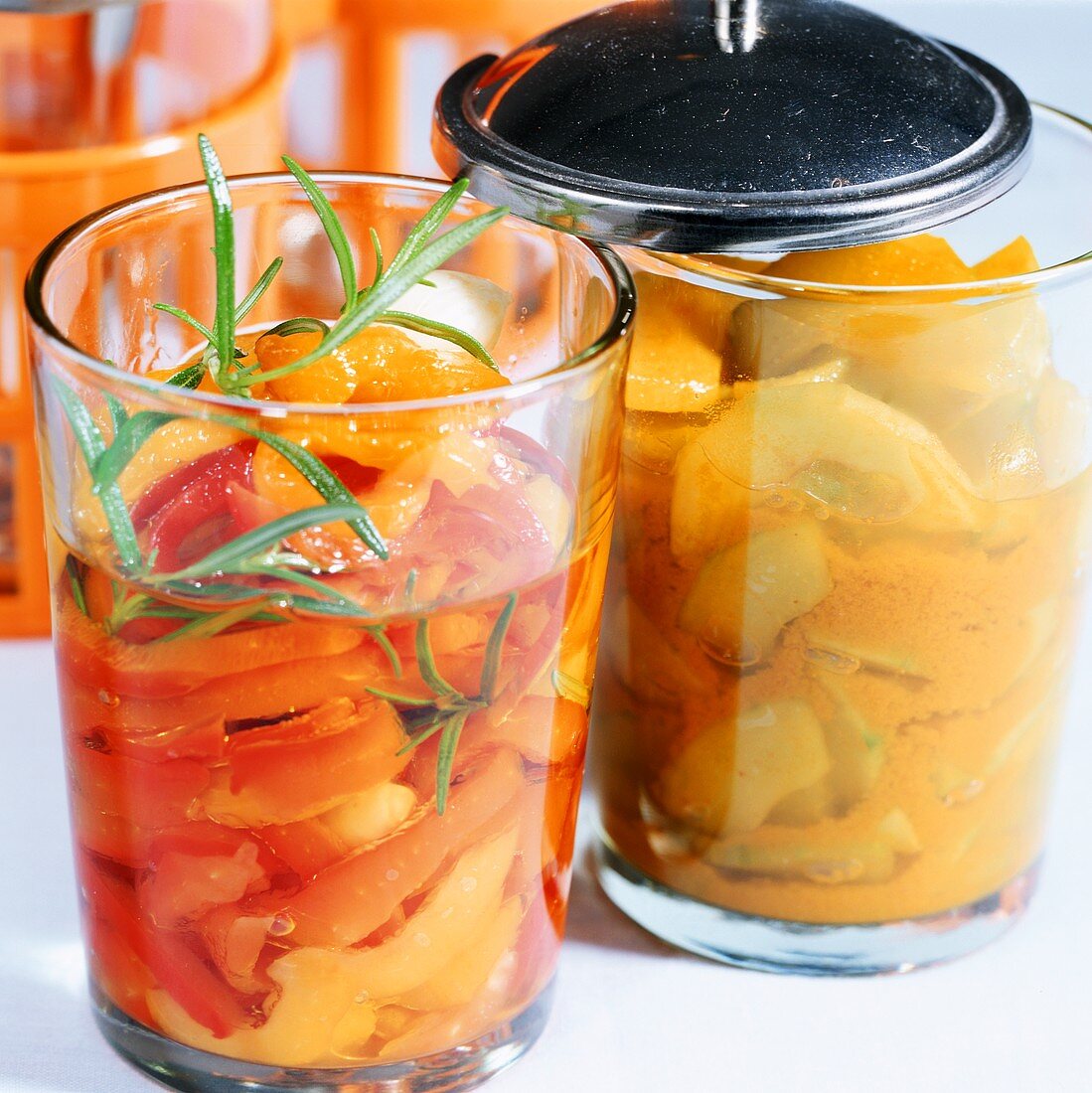 Pickled peppers and gherkins with turmeric in jars