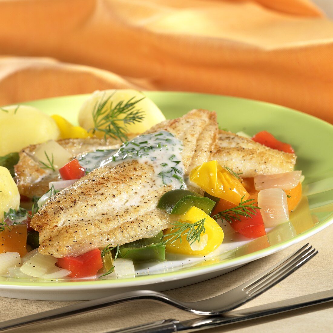 Plaice fillets with herb sauce on peppers