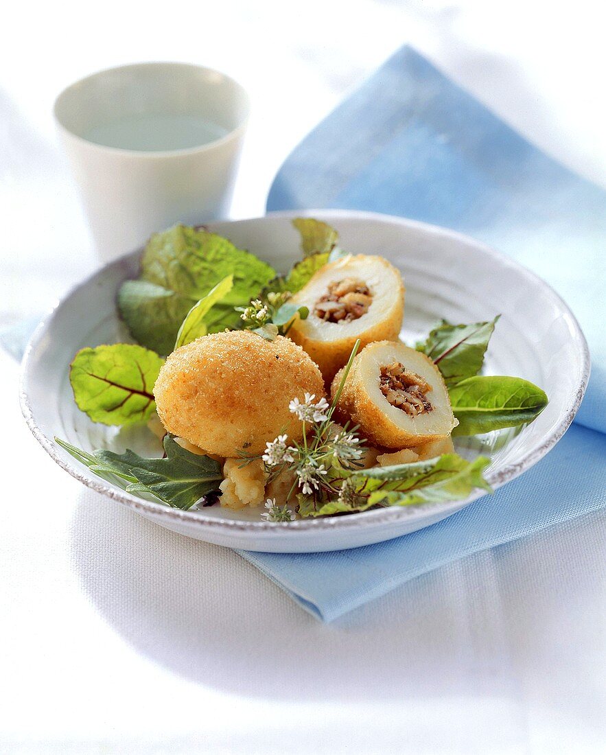 Deep-fried potatoes with walnut and anchovy stuffing on lettuce