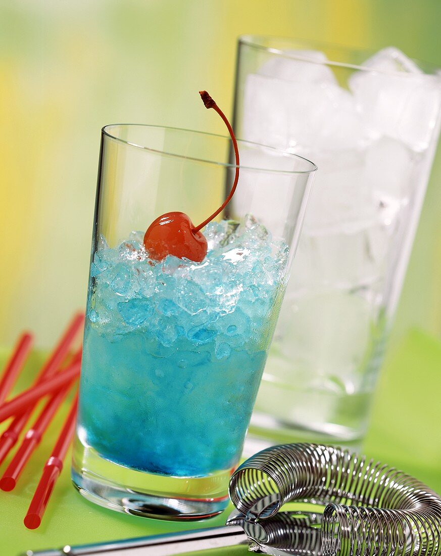 Blue Curacao drink with crushed ice & cocktail cherry