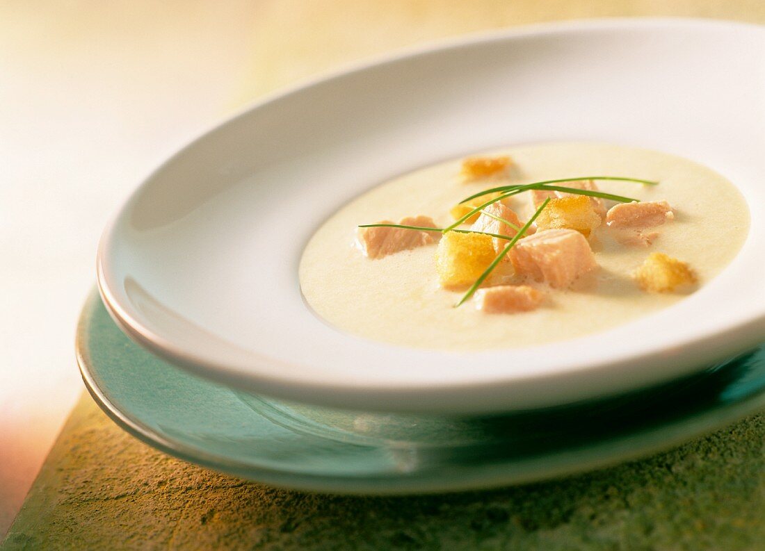 Cream of potato soup with salmon and croutons