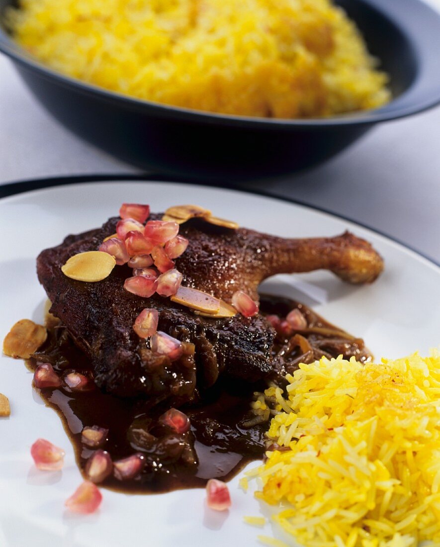 Roast duck leg with saffron rice and pomegranate sauce