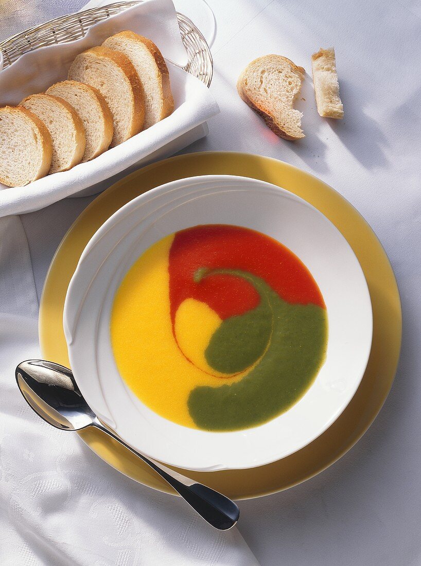 Red, yellow and green pepper soup in a plate