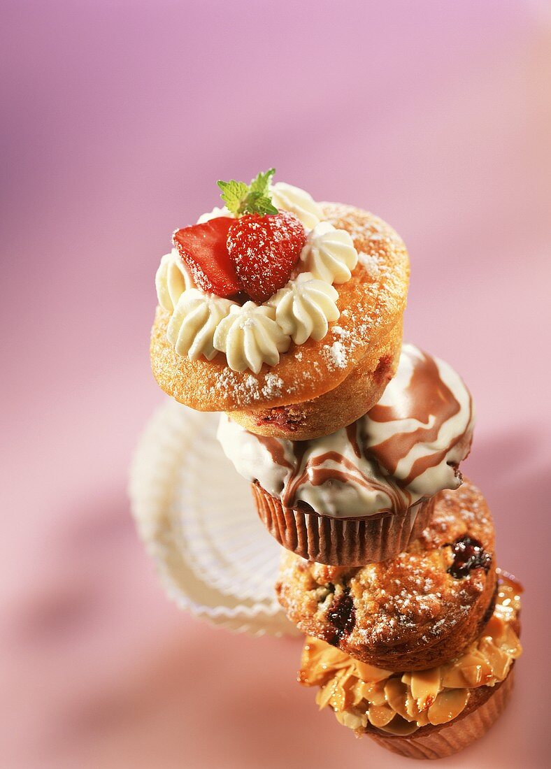 Four muffins on top of each, the top one with strawberries