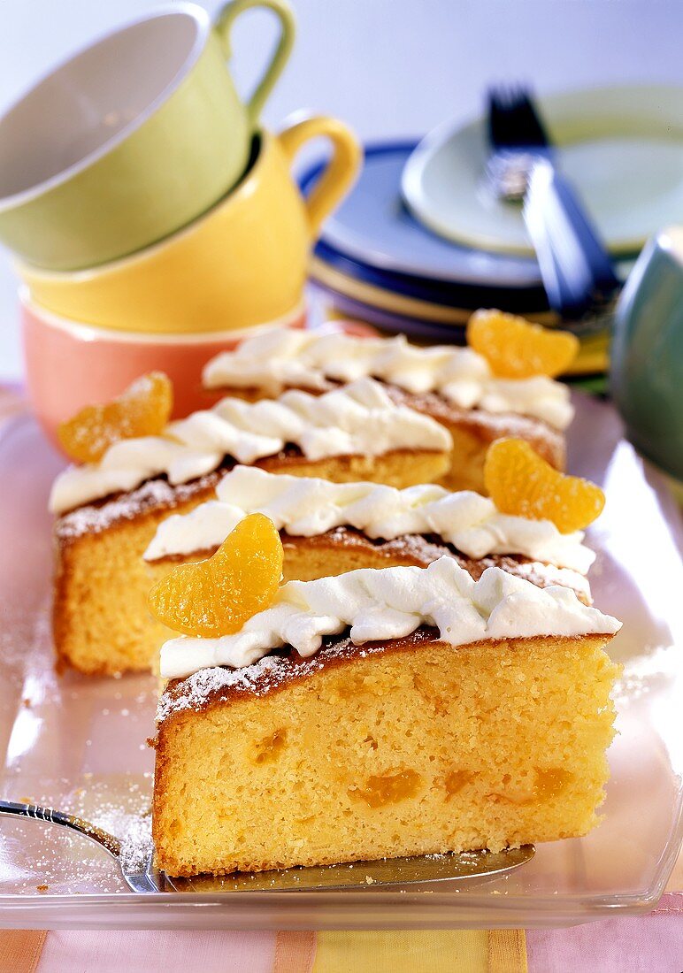 A few pieces of mandarin cake on cake plate