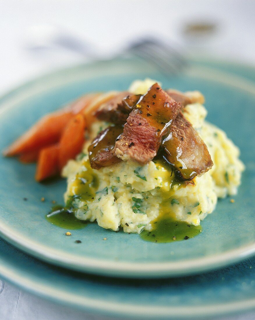 Strips of beef with herb sauce and herb mashed potatoes