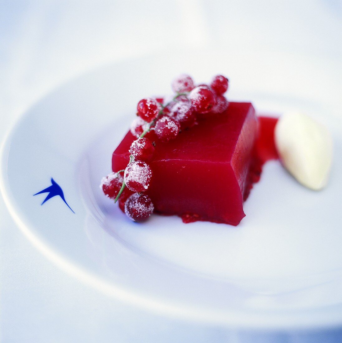 Turned-out redcurrant jelly & vanilla ice cream on plate