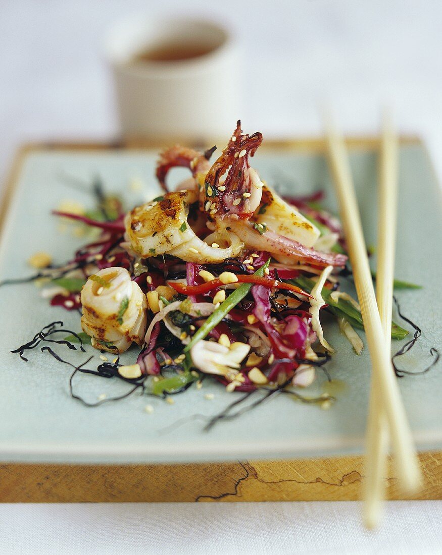 Cuttlefish with sesame and chili on Asian salad