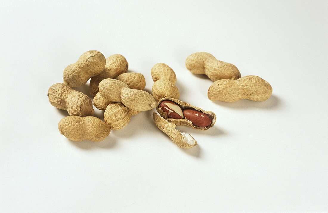Peanuts in their shells, one opened