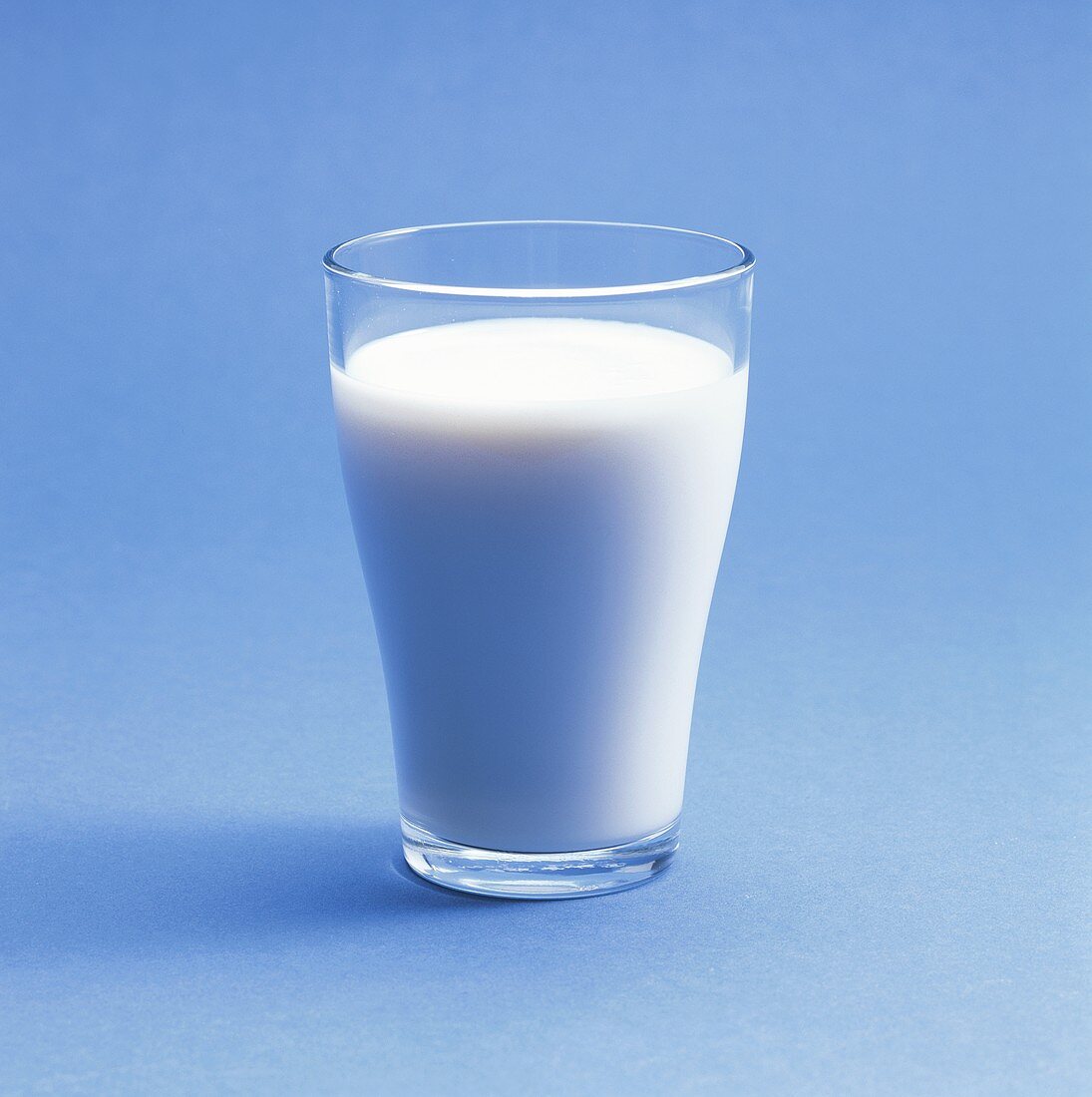 A glass of milk on a blue background