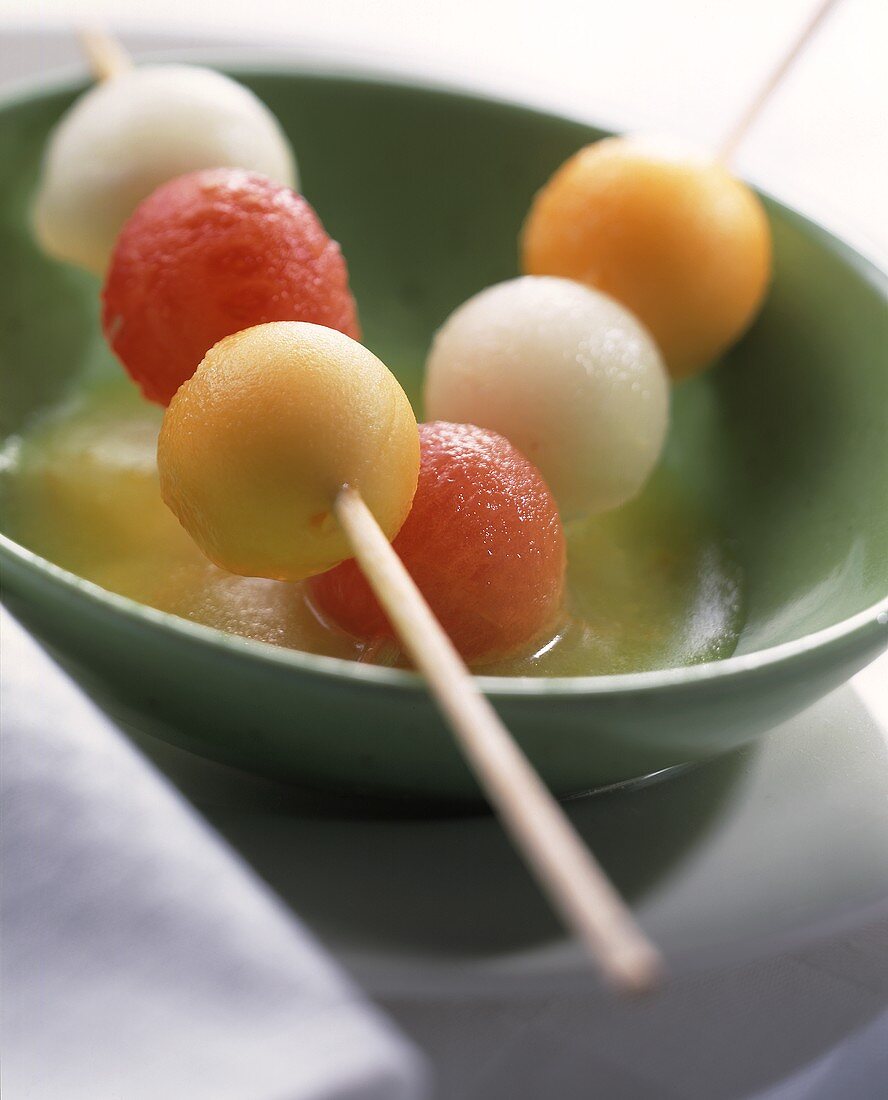 Colourful melon balls on cocktail sticks