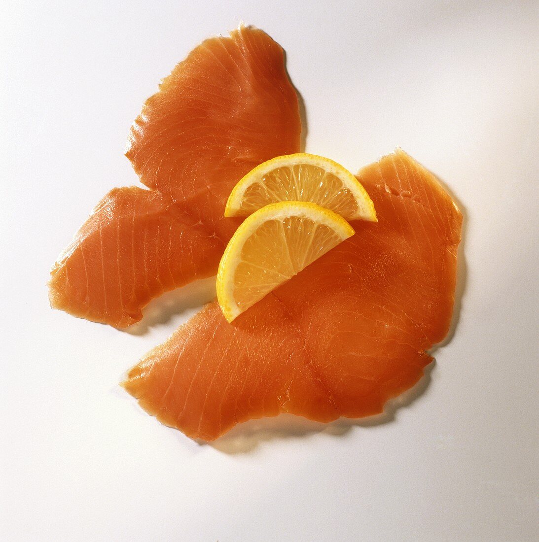Two slices of smoked wild salmon garnished with lemon